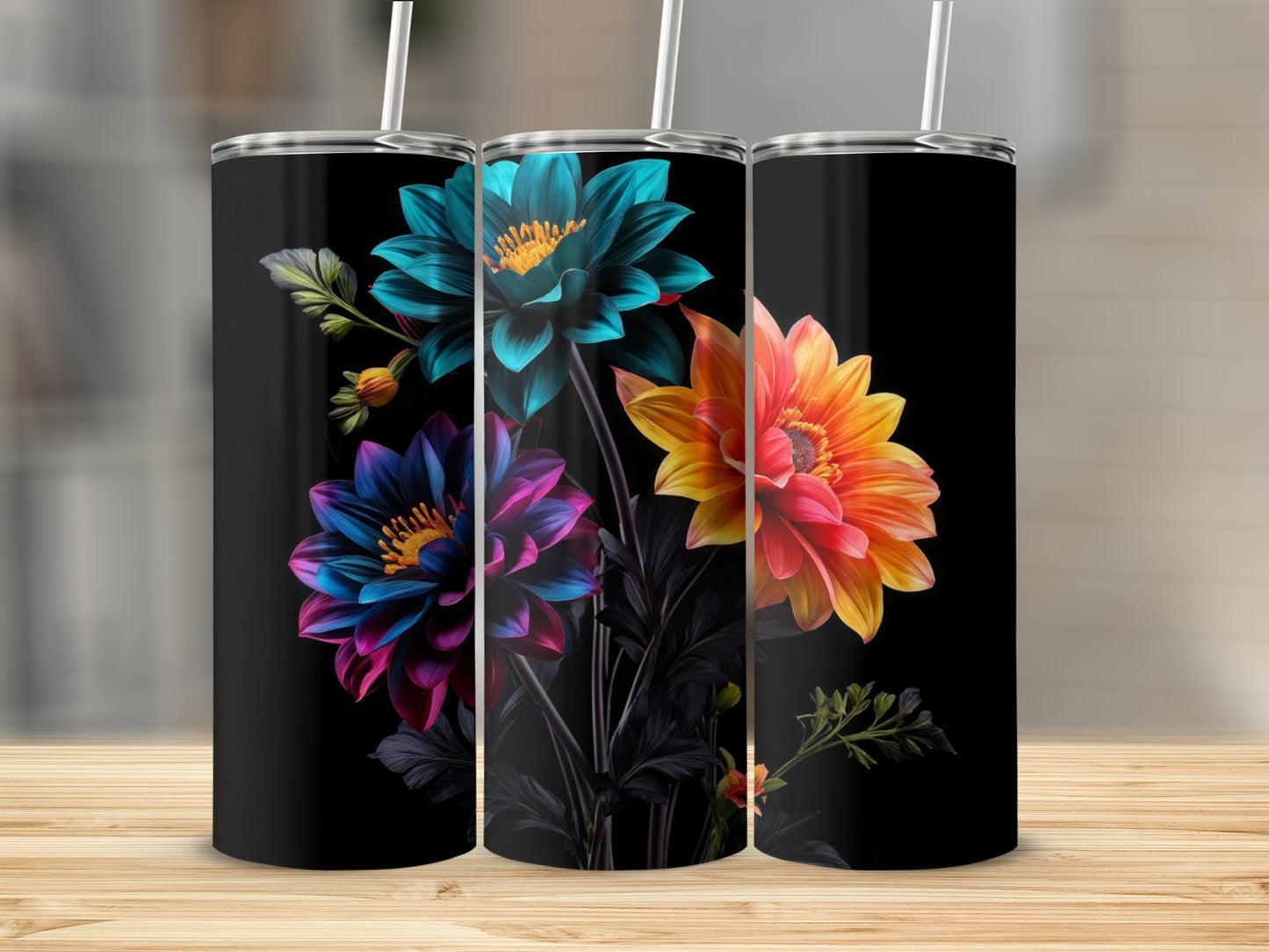 Three tumblers with vibrant floral designs against a black background.