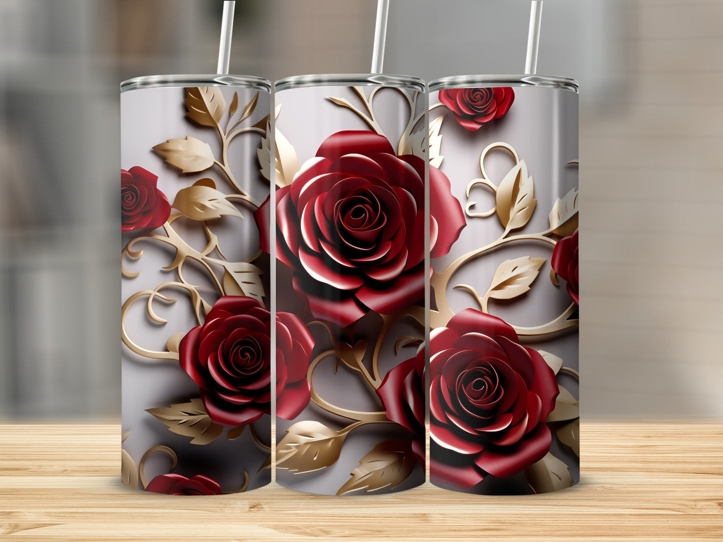 Three tumblers with realistic red roses and gold scrolling foliage on a light gray background.