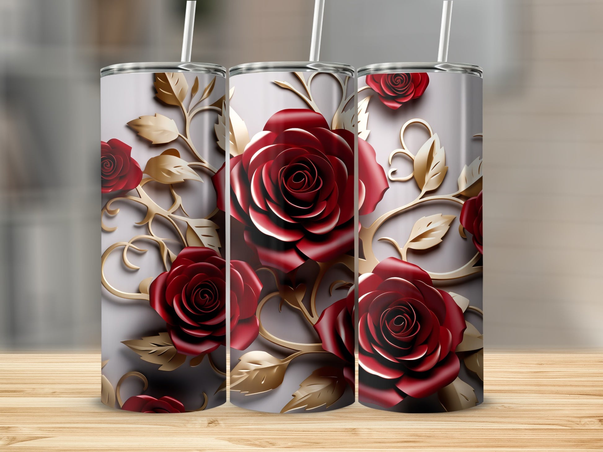 Three tumblers with realistic red roses and gold scrolling foliage on a light gray background.
