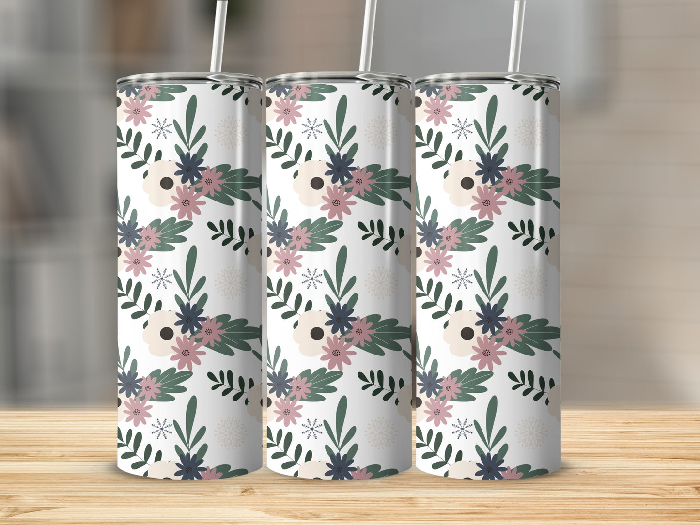 Three tumblers with a floral pattern on a wooden surface.