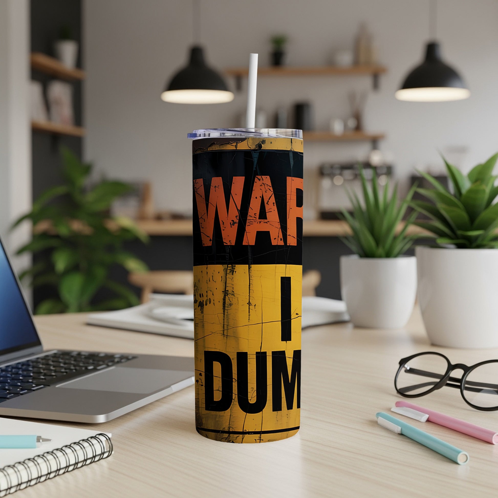 Yellow and black tumbler with "WAR i DUMP" text, on a desk.