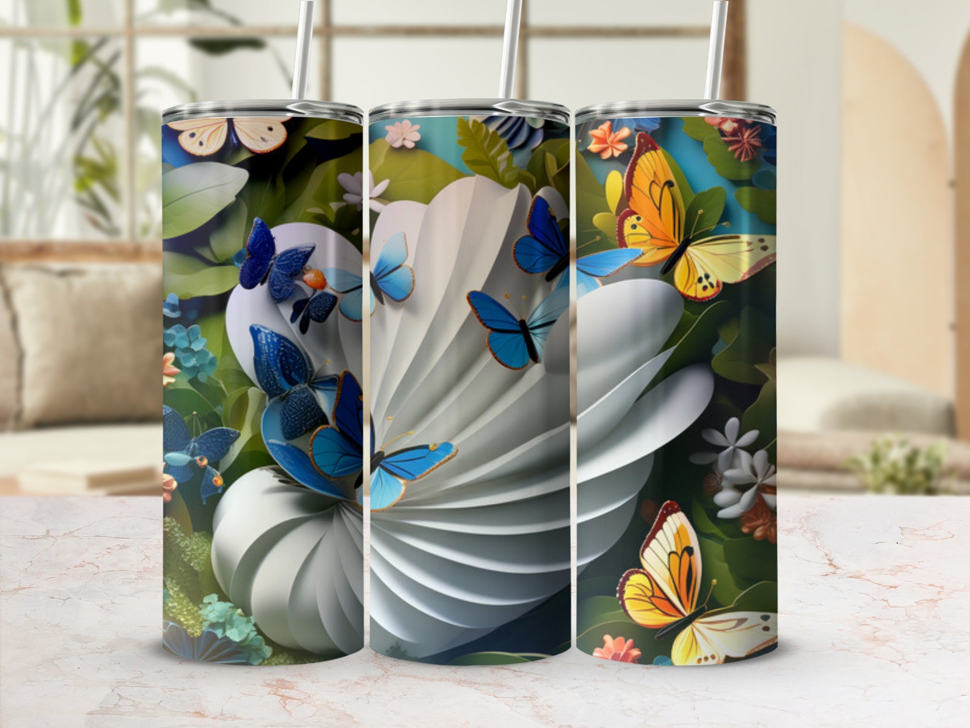 Three tumblers with butterfly and floral designs, displayed with straws.