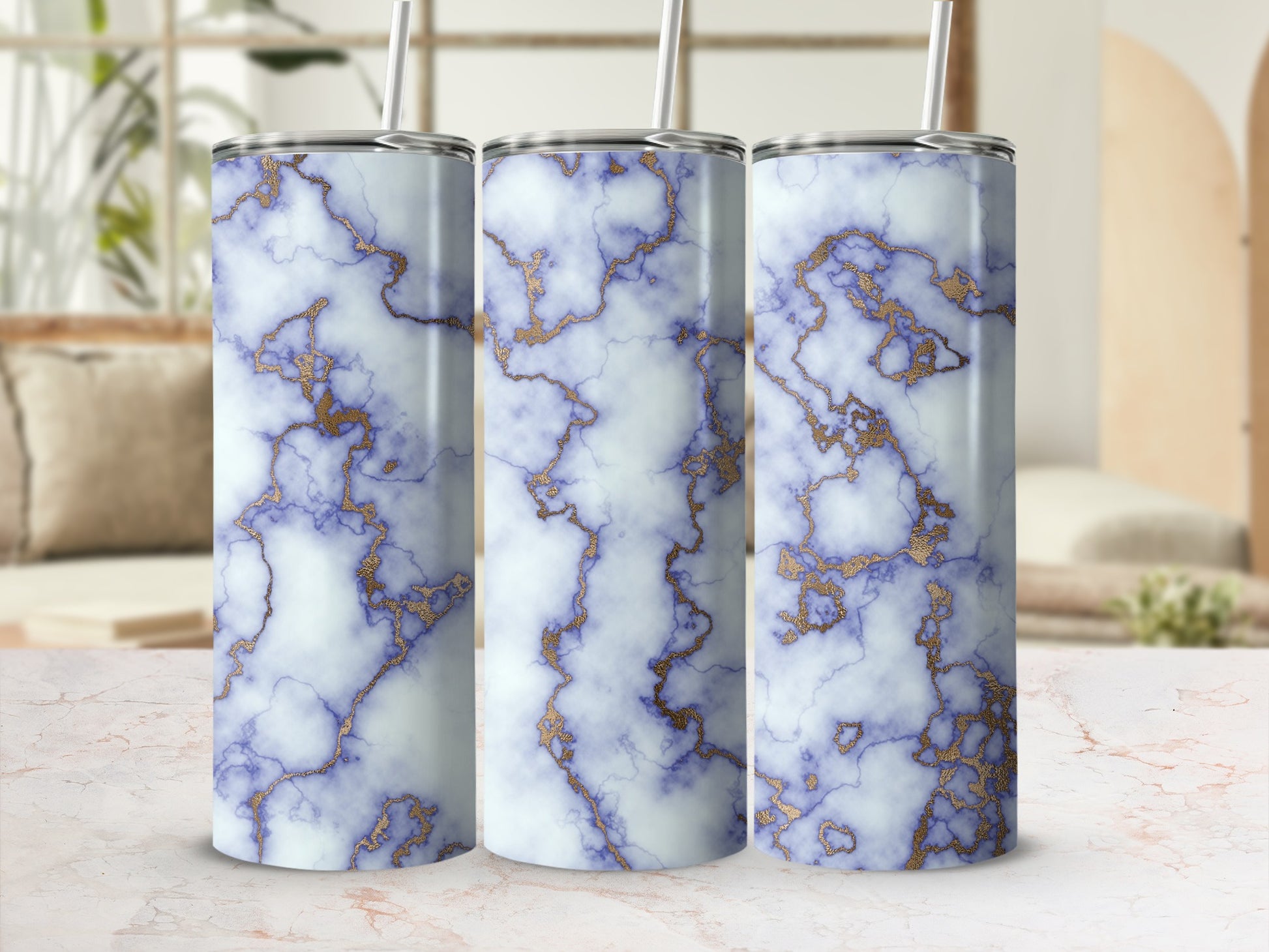 Three tumblers with blue marble and gold veining patterns.