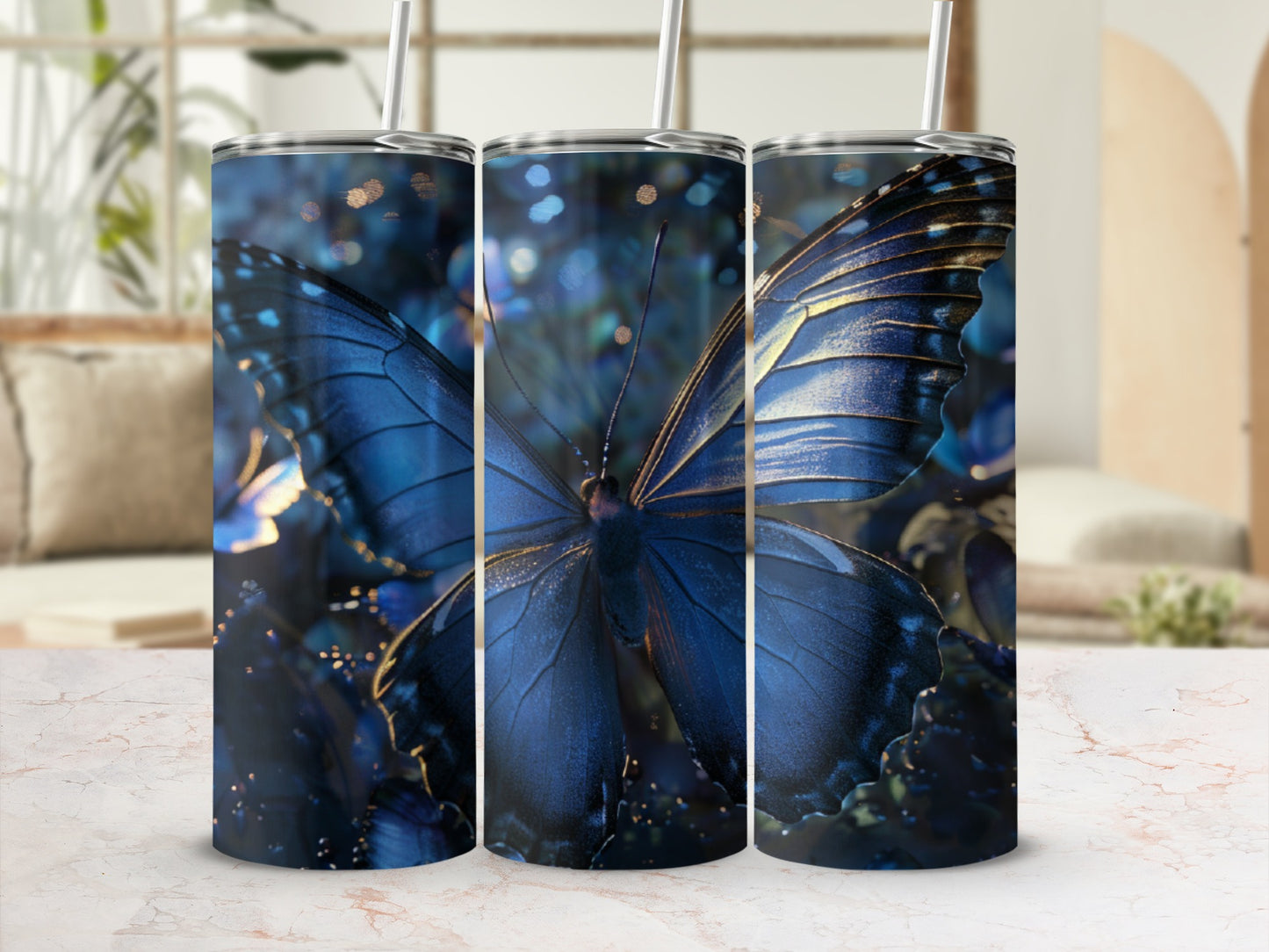 Three tumblers with a close-up, blue butterfly design and bokeh background.