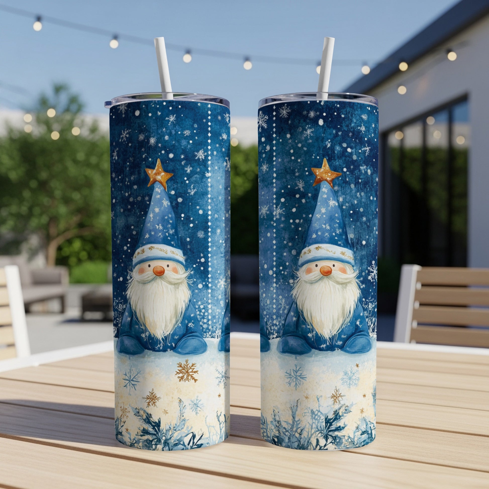 Two skinny tumblers featuring a blue gnome with a star hat and snowflakes.
