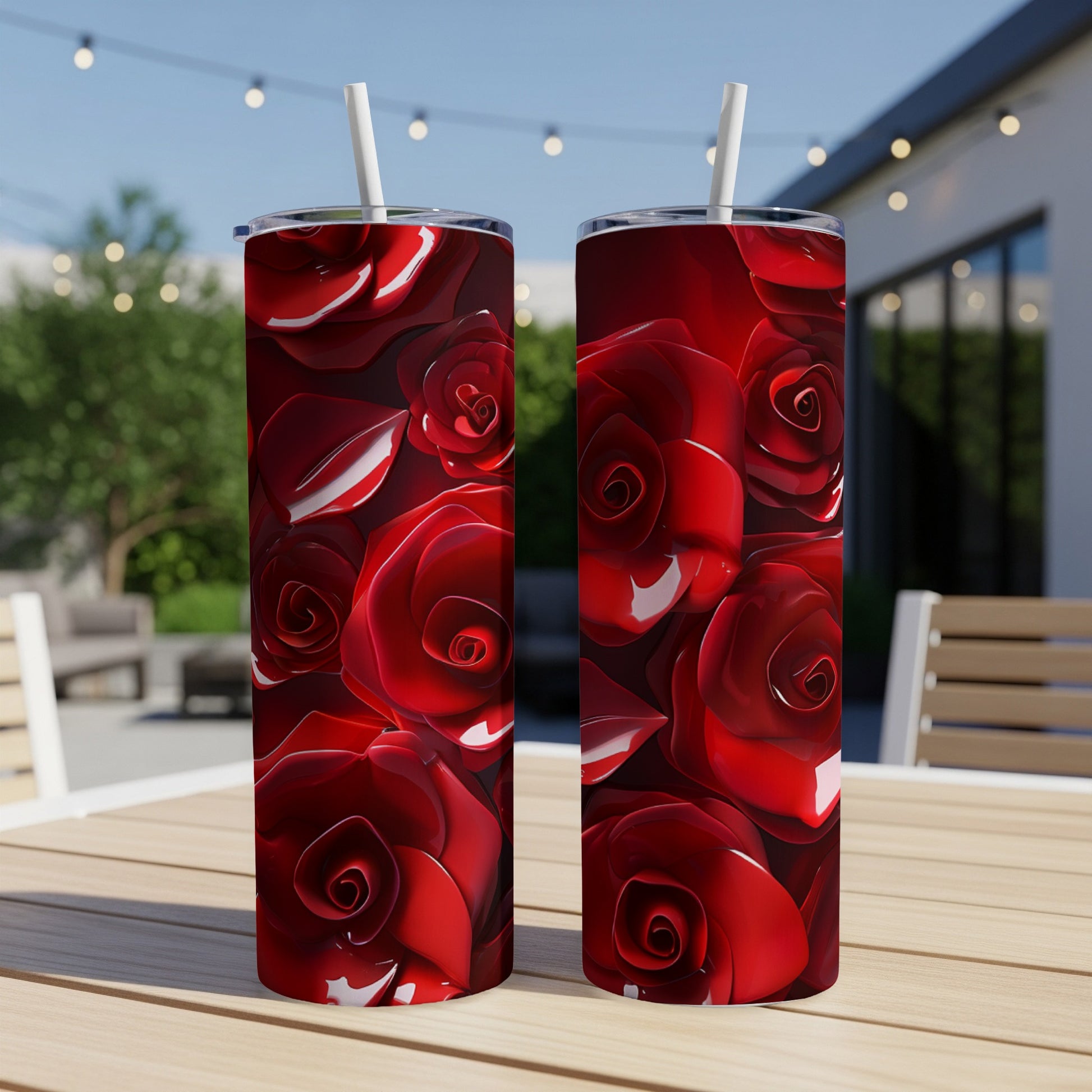 Two tumblers with a vibrant red rose pattern, resting on a wooden table.
