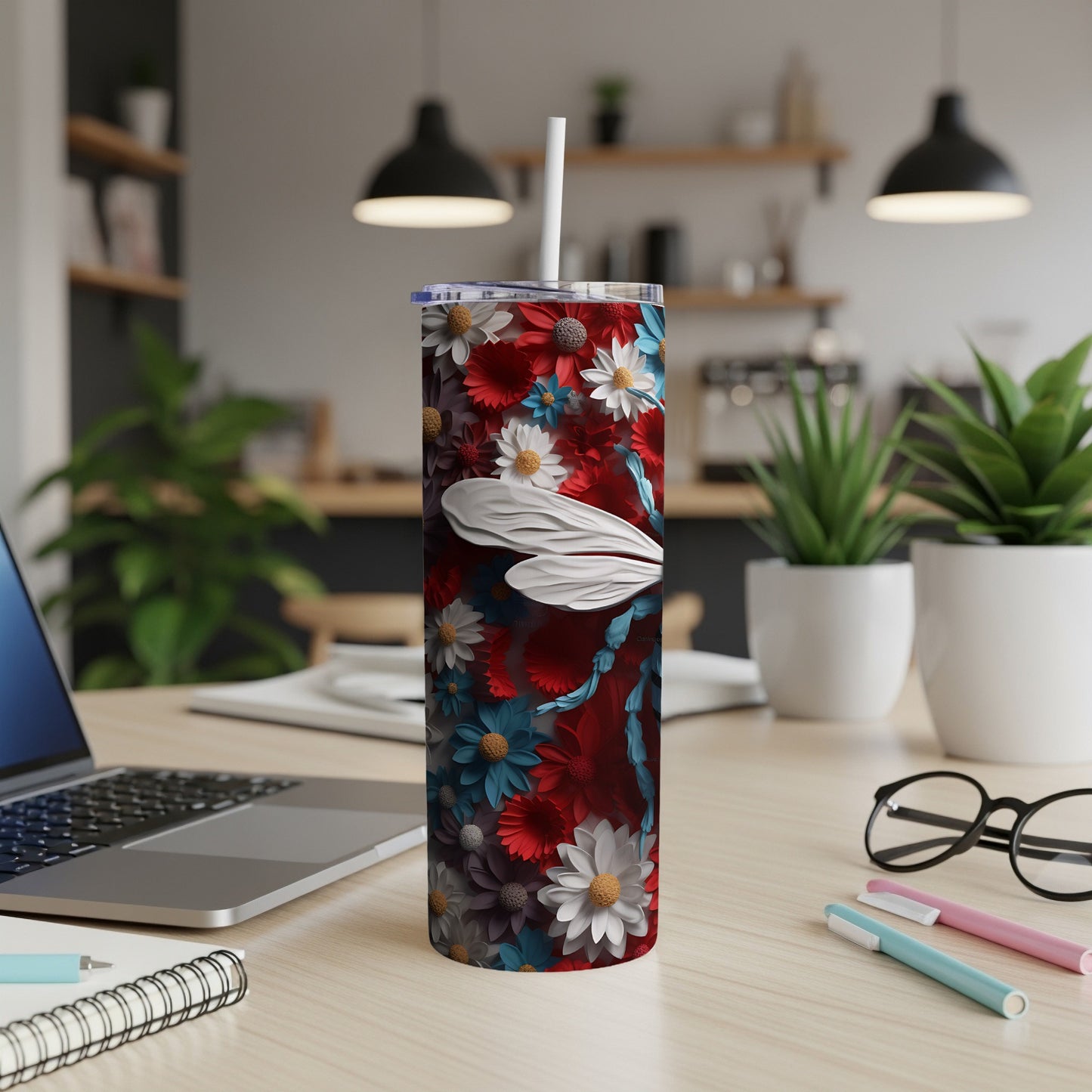 Red tumbler with floral pattern and dragonfly illustration.