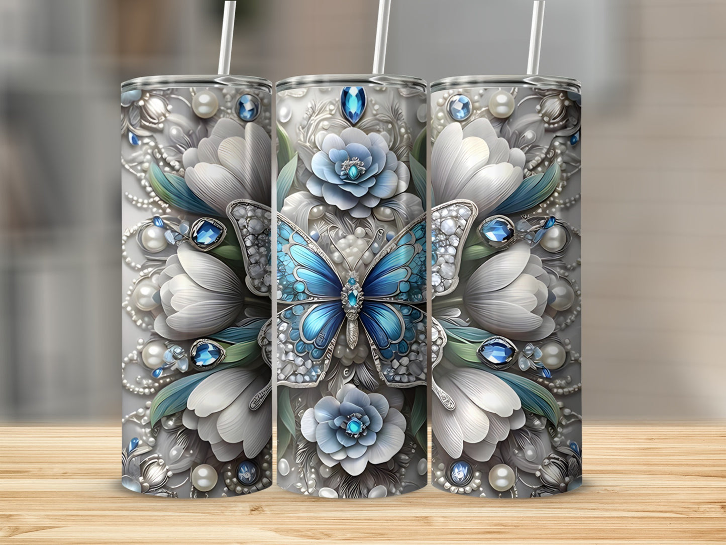 Silver tumbler with blue butterfly, white flowers, and gemstone accents.