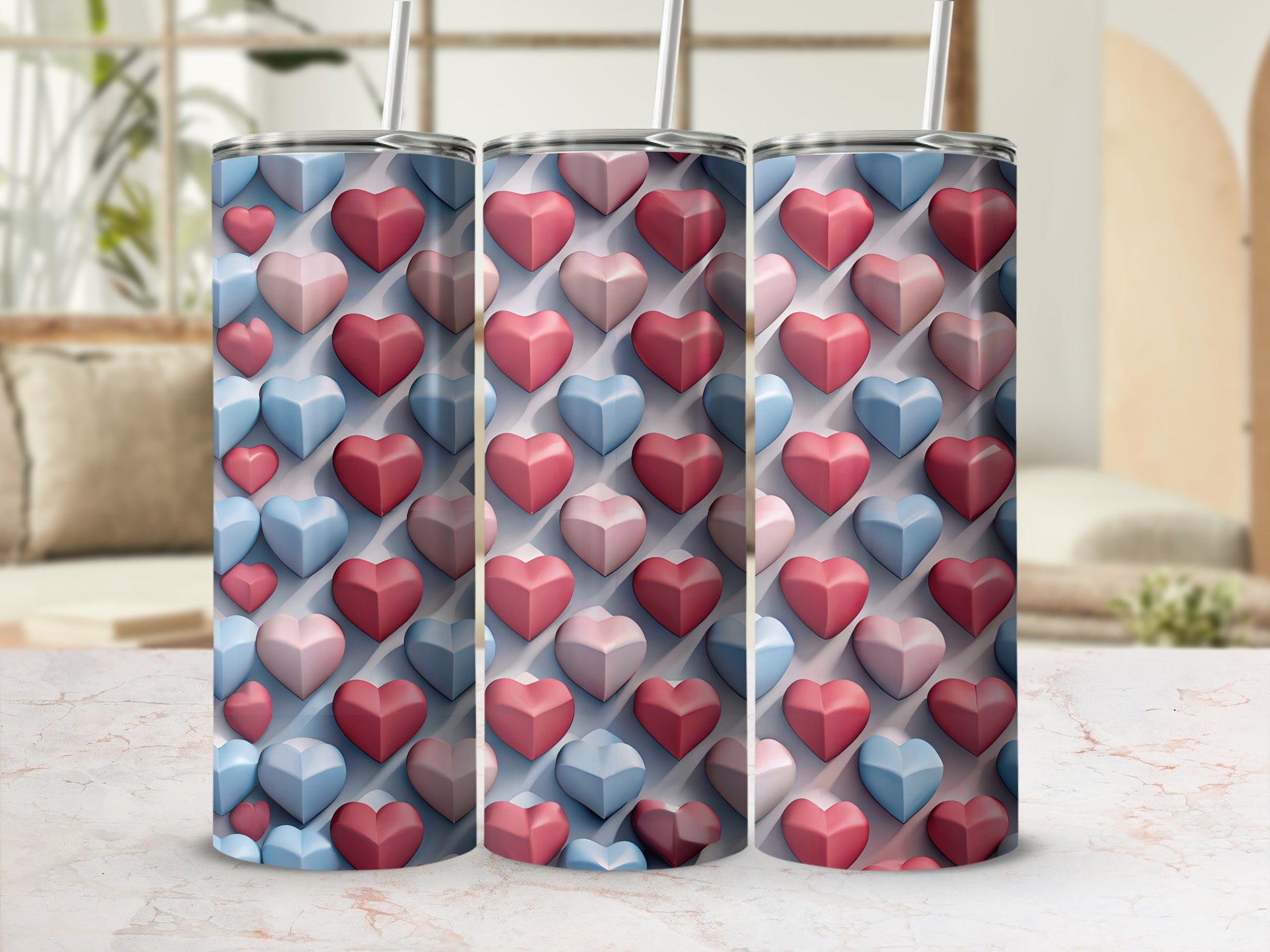 Three tumblers adorned with a repeating pattern of pink and blue hearts.