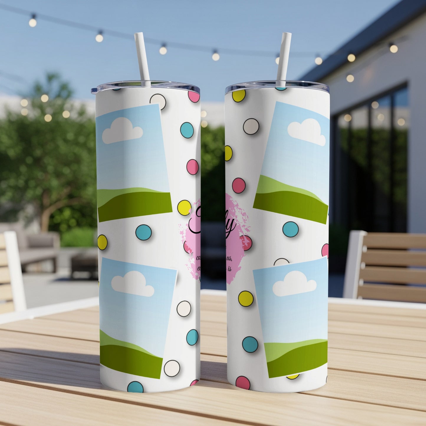 Two tumblers with a polka dot and photo frame design featuring clouds and hills.