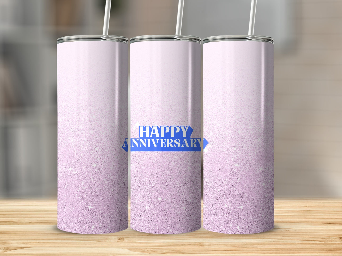 Three pink glitter tumblers with "Happy Anniversary" text on the middle one.
