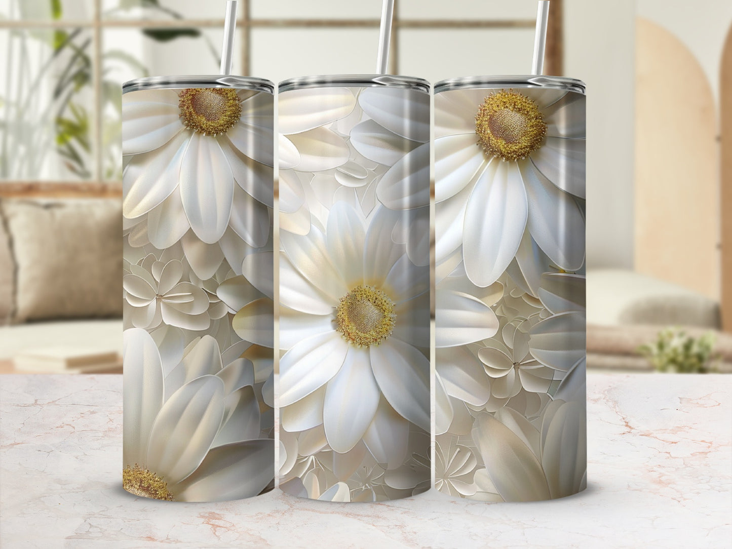 Three white daisy floral patterned tumblers with straws, displayed on a marble surface.
