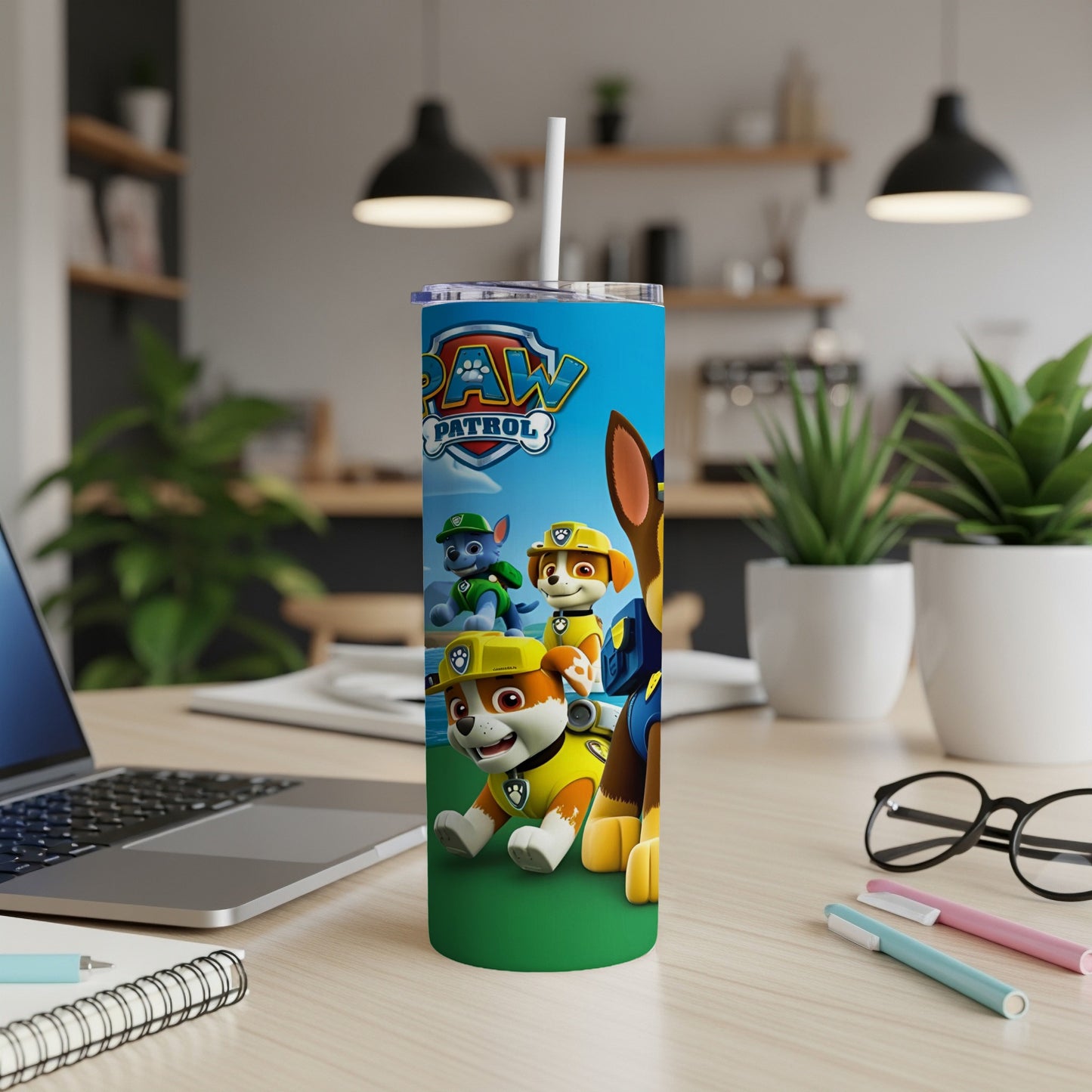 Paw Patrol characters Ryder, Chase, and Marshall on a blue tumbler with a straw.