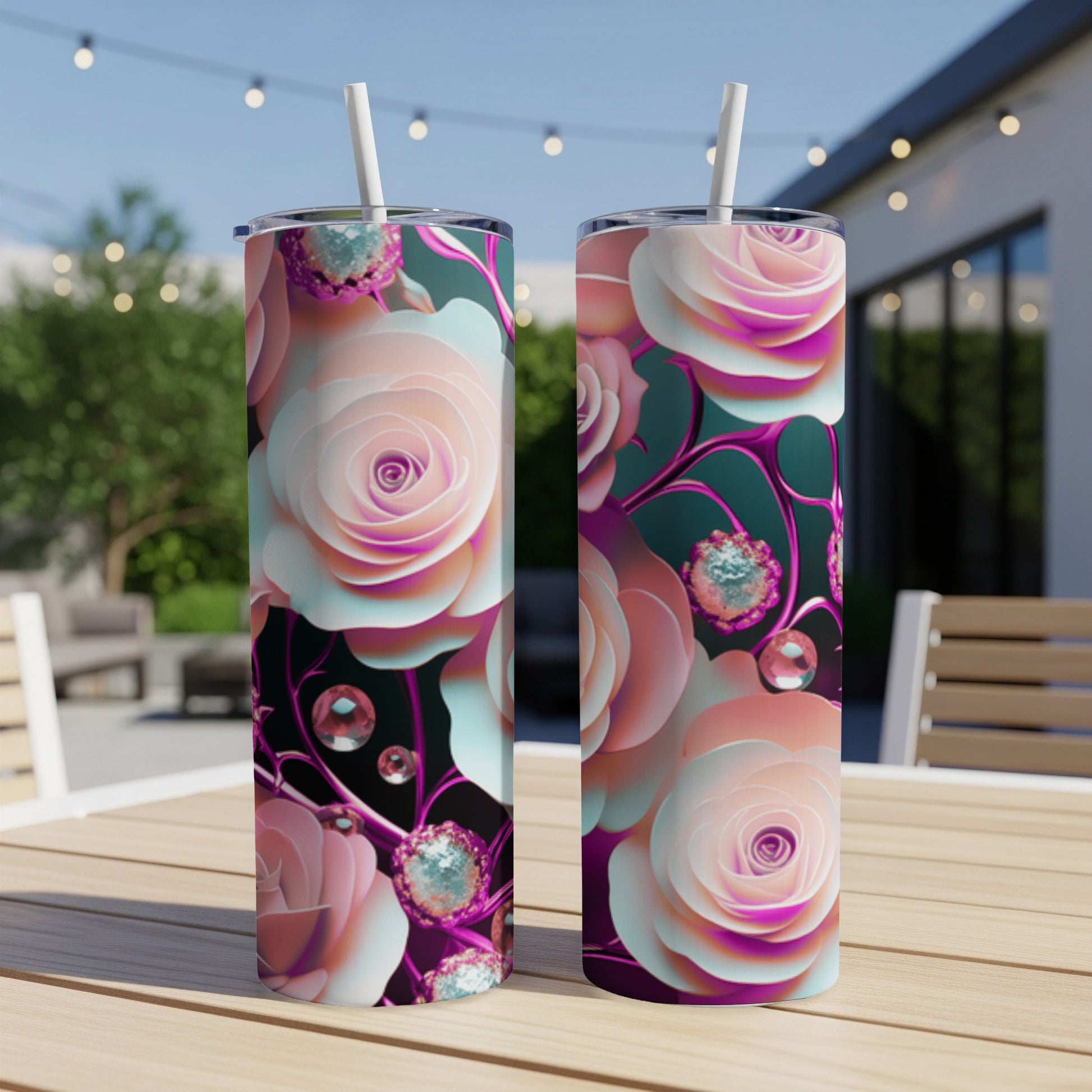Two tall tumblers with pink and white roses, jewels, and straws.