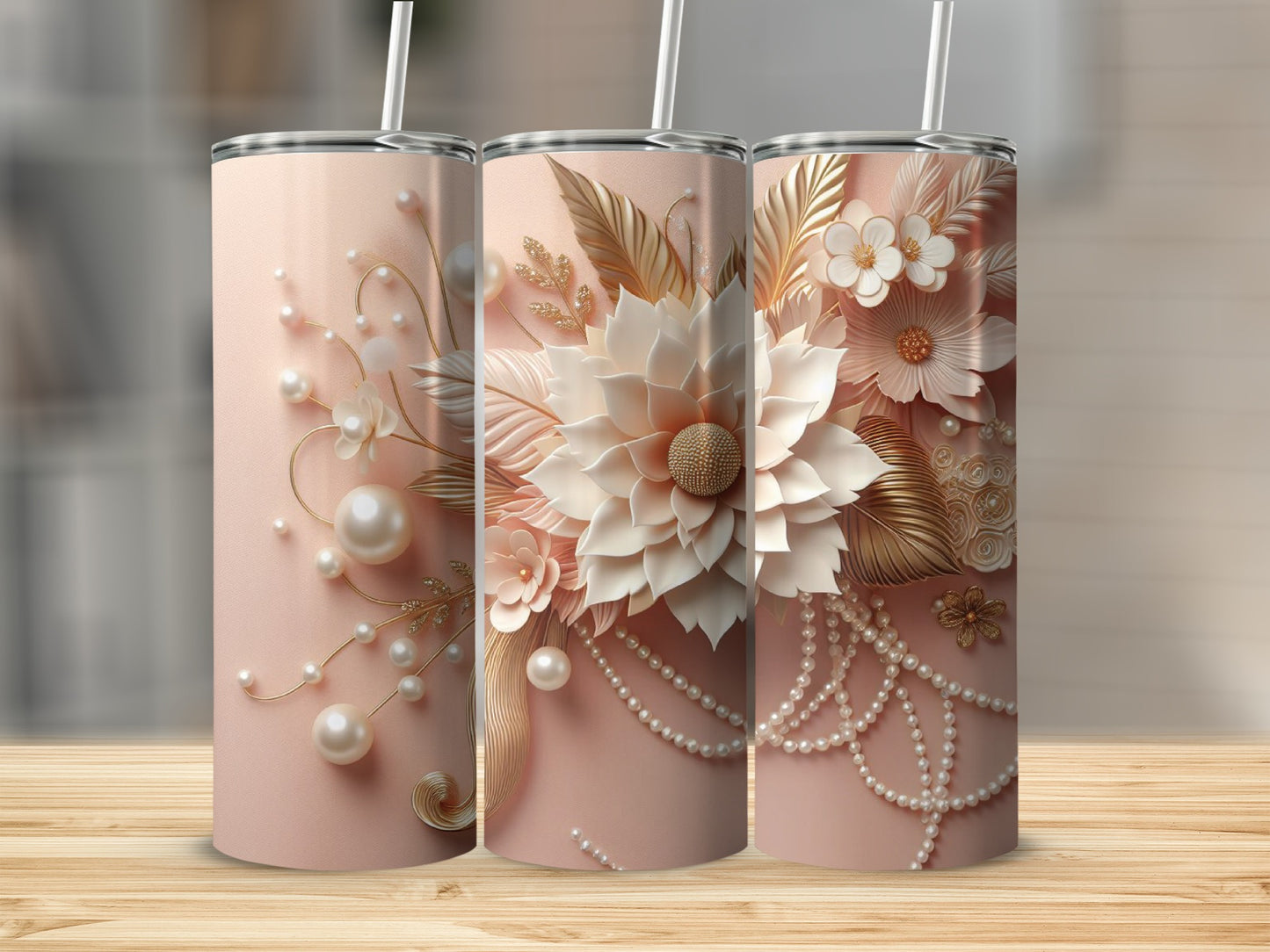 Three pastel pink tumblers with floral and pearl embellishments.