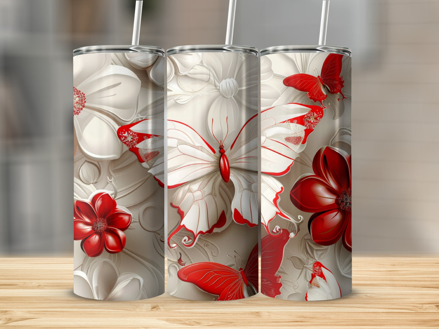 Three tumblers with white and red floral and butterfly designs.