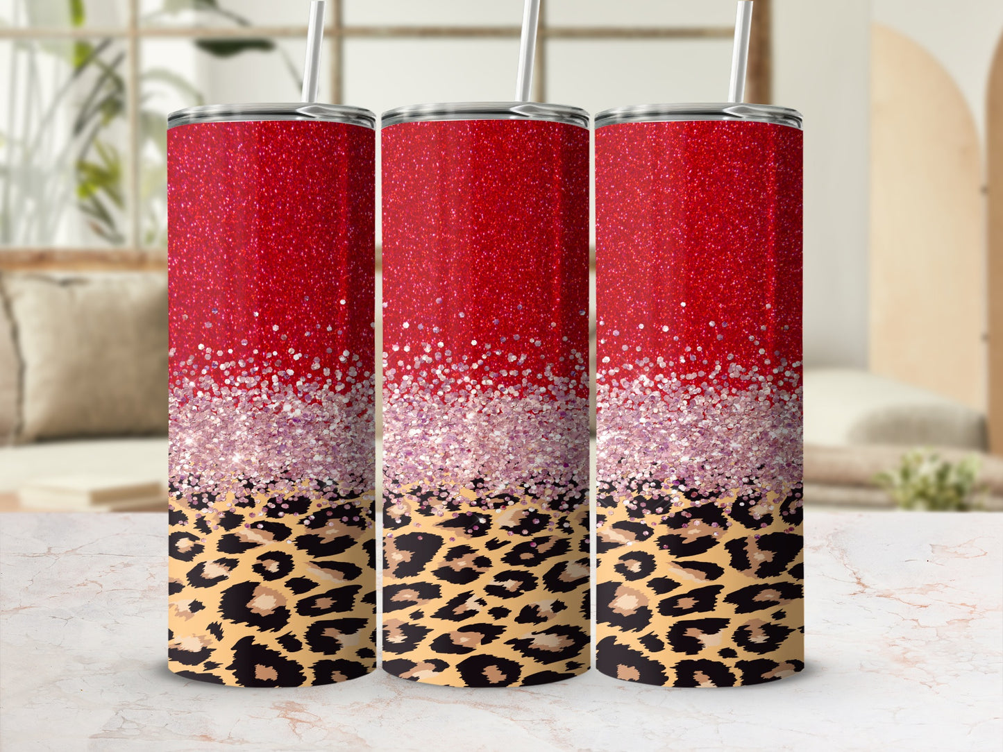 Three glitter-covered tumblers with leopard print bases.