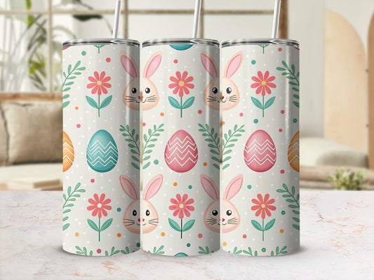 Easter tumbler with bunnies, flowers, and eggs on a light background.