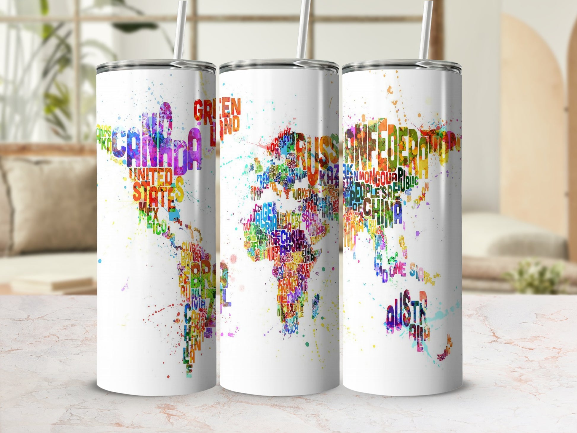 Three tumblers with colorful world map designs made of country names.