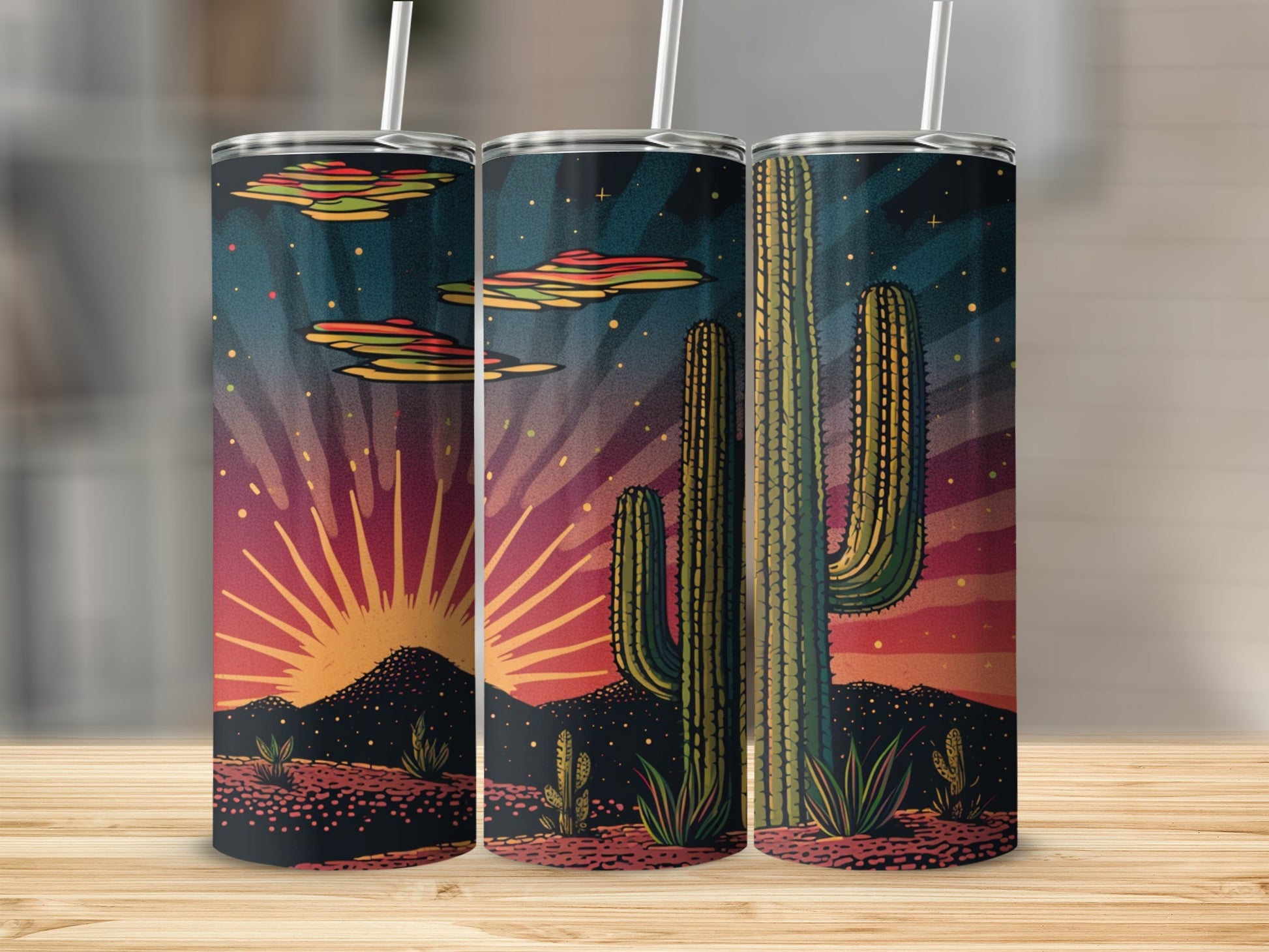 Three tumblers with a desert sunset scene featuring saguaro cacti and colorful clouds.