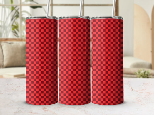Three red checkered tumblers with straws on a marble surface.