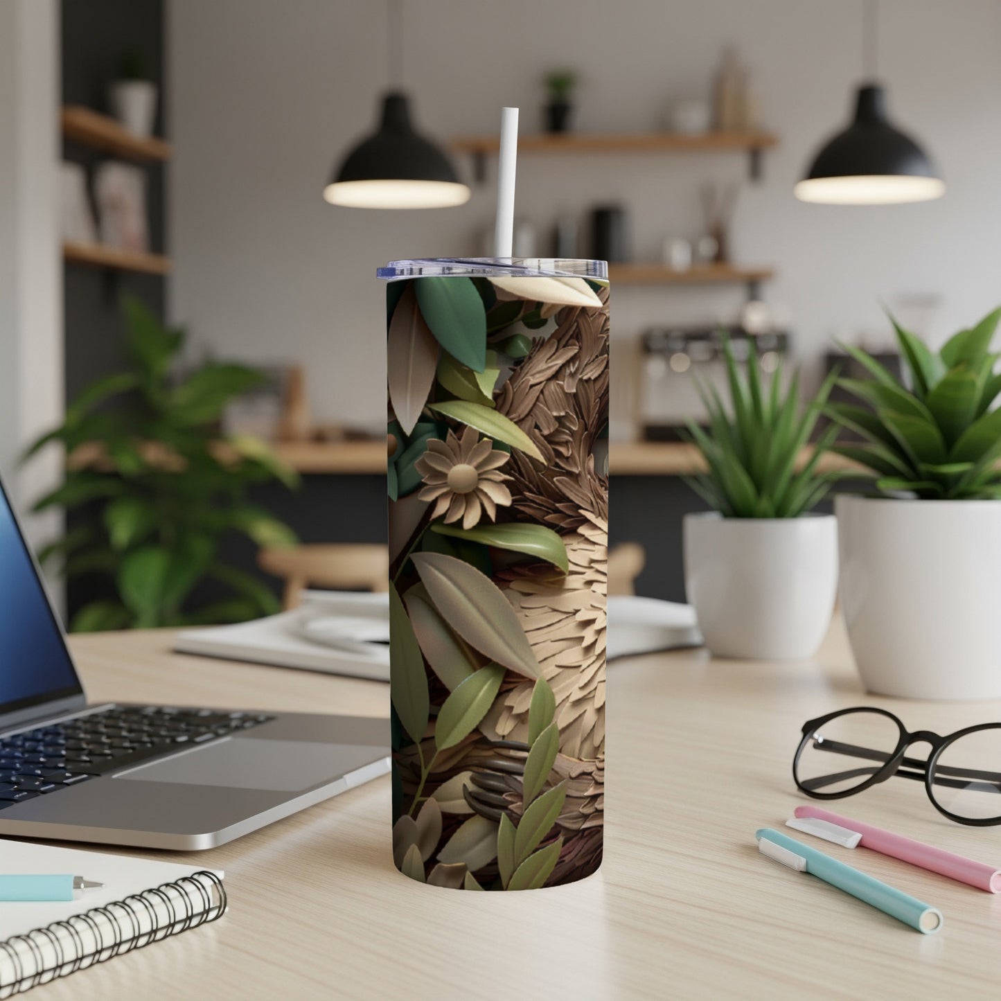 Woodland animal illustration on a white tumbler with straw on a desk.
