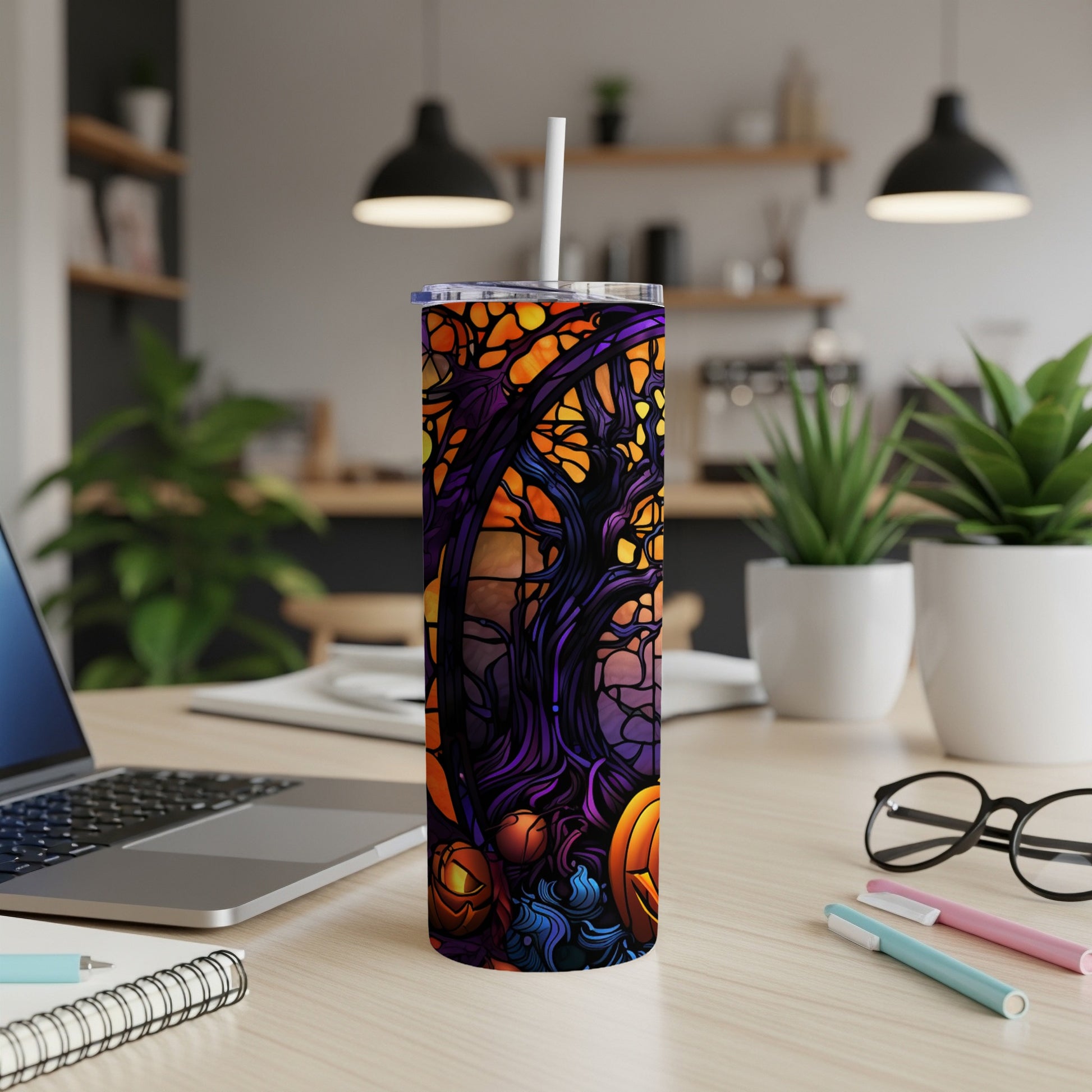 Halloween tumbler with pumpkins and spooky trees design.