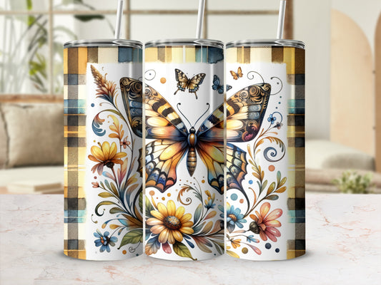 Three tumblers with butterfly and floral design on plaid background.