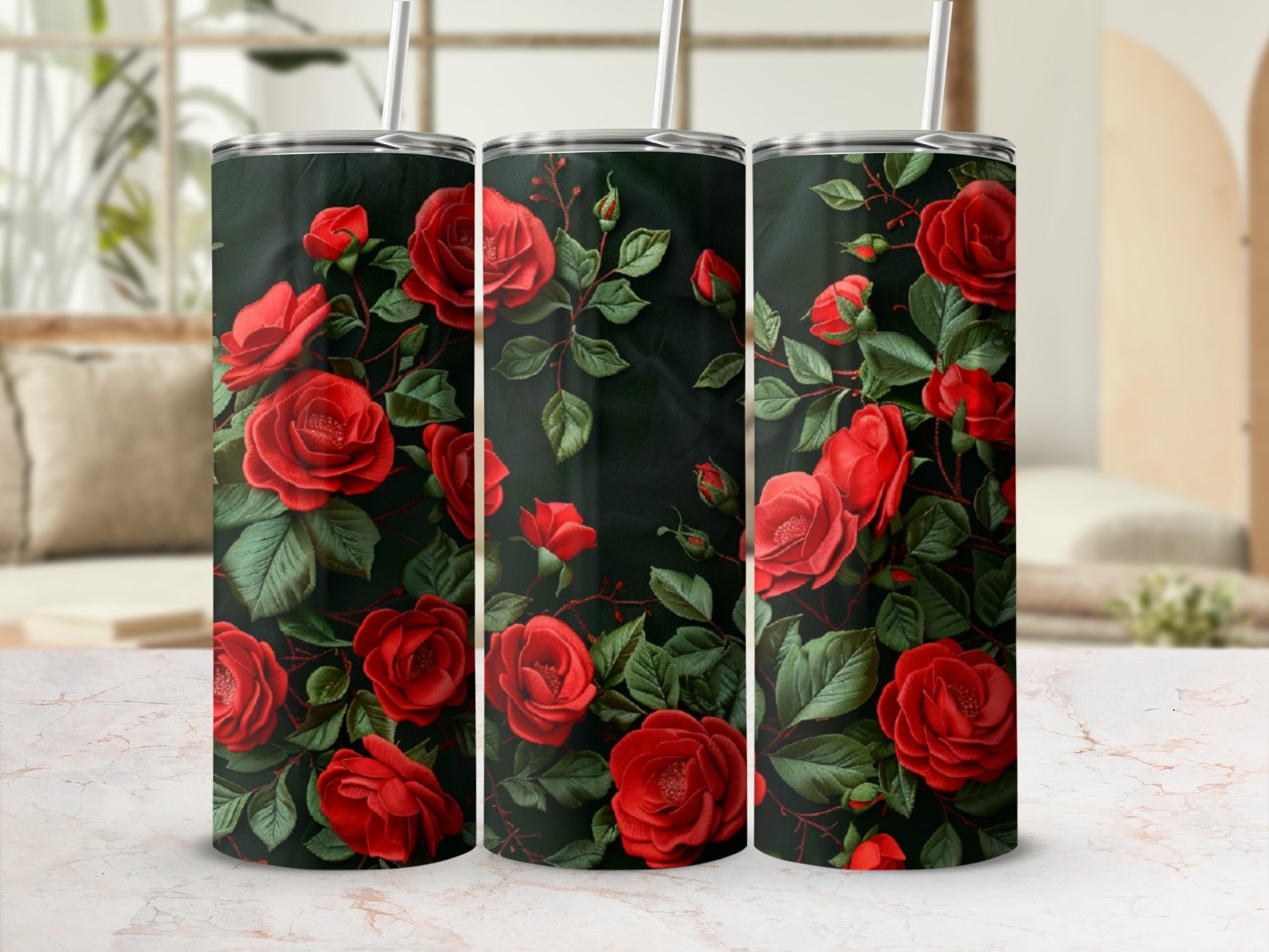 Three tumblers adorned with a pattern of deep red roses and green leaves.