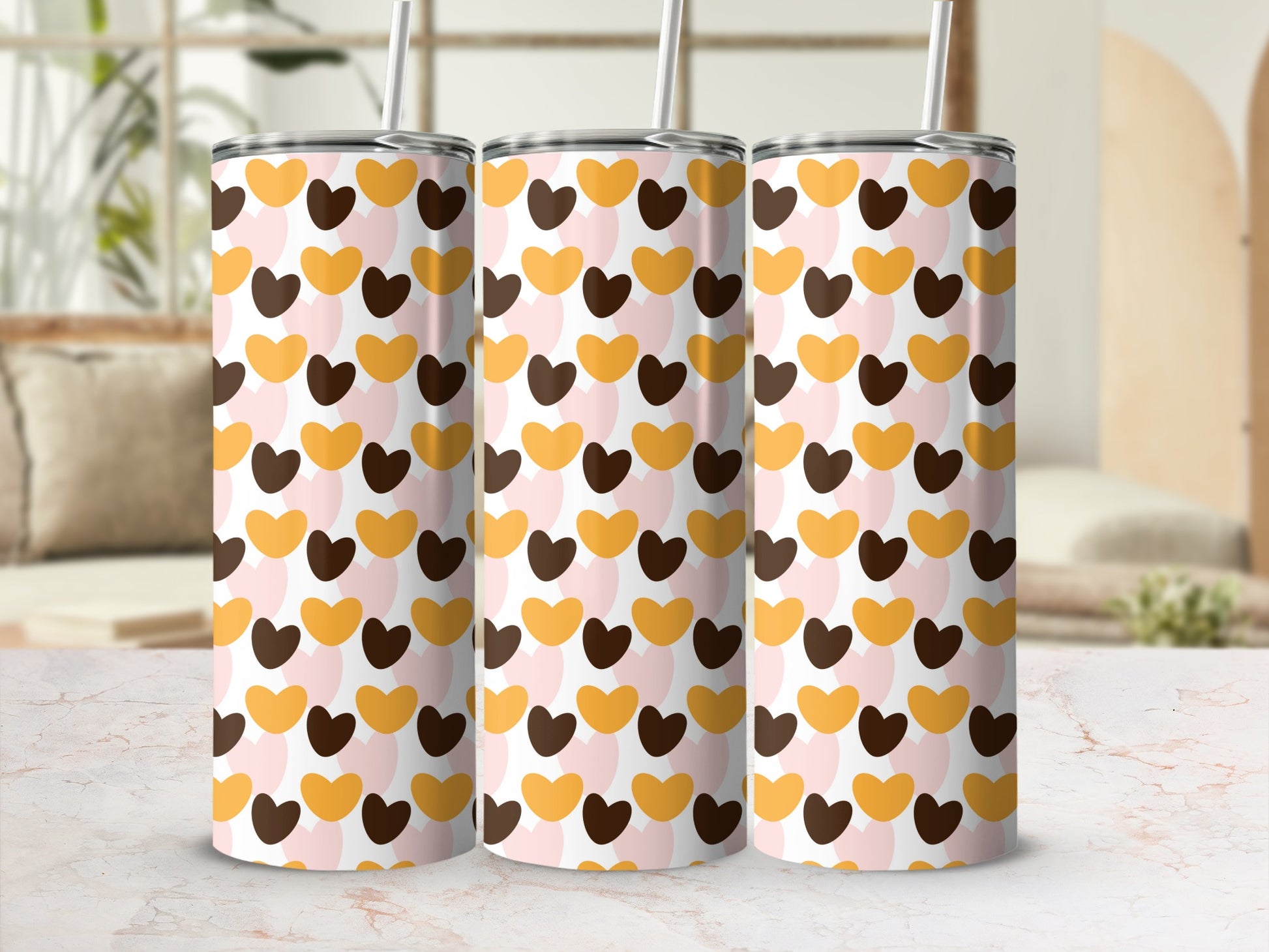 Three tumblers with a pattern of pink, brown, and gold hearts.