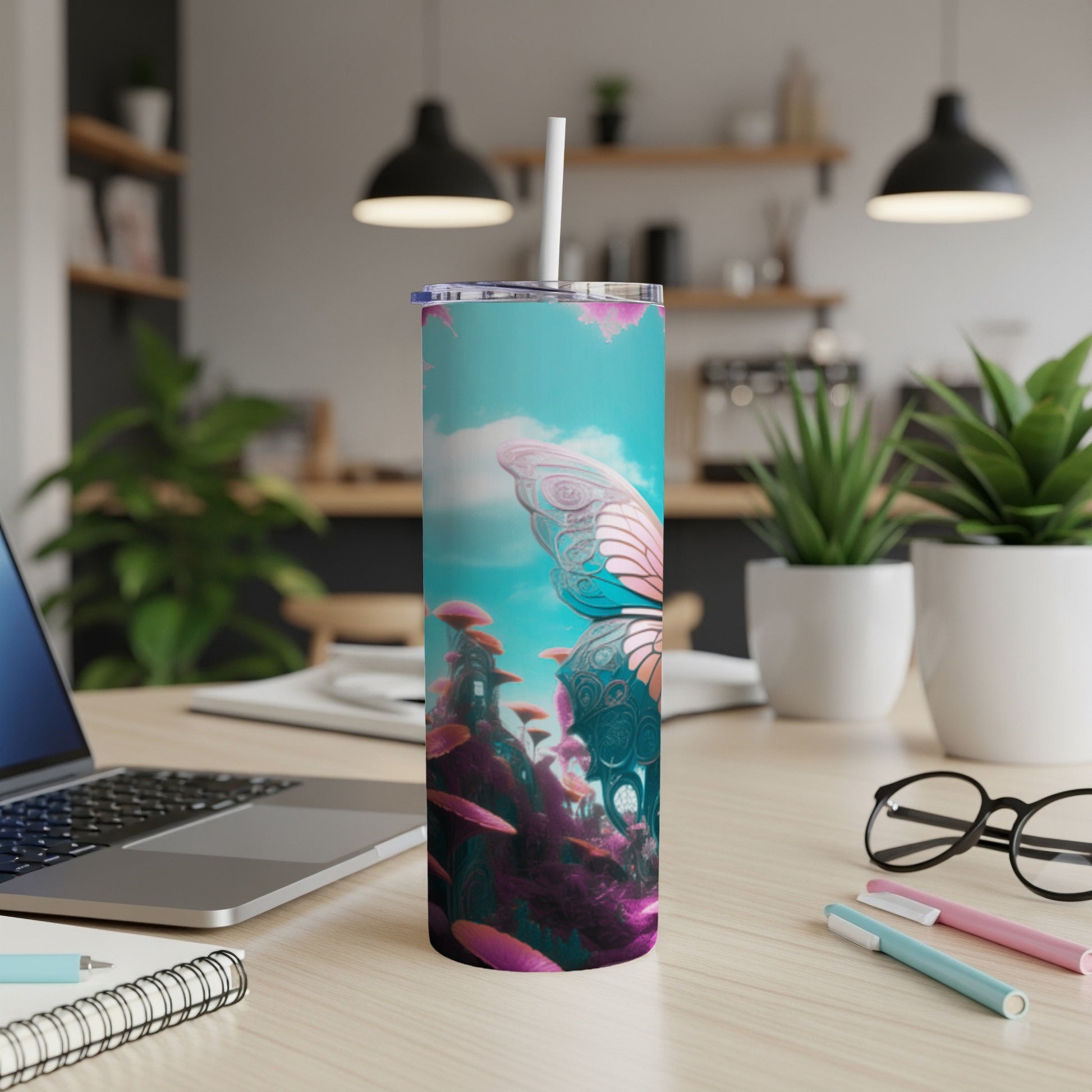 Tumbler with butterfly and mushroom fantasy design on a desk.