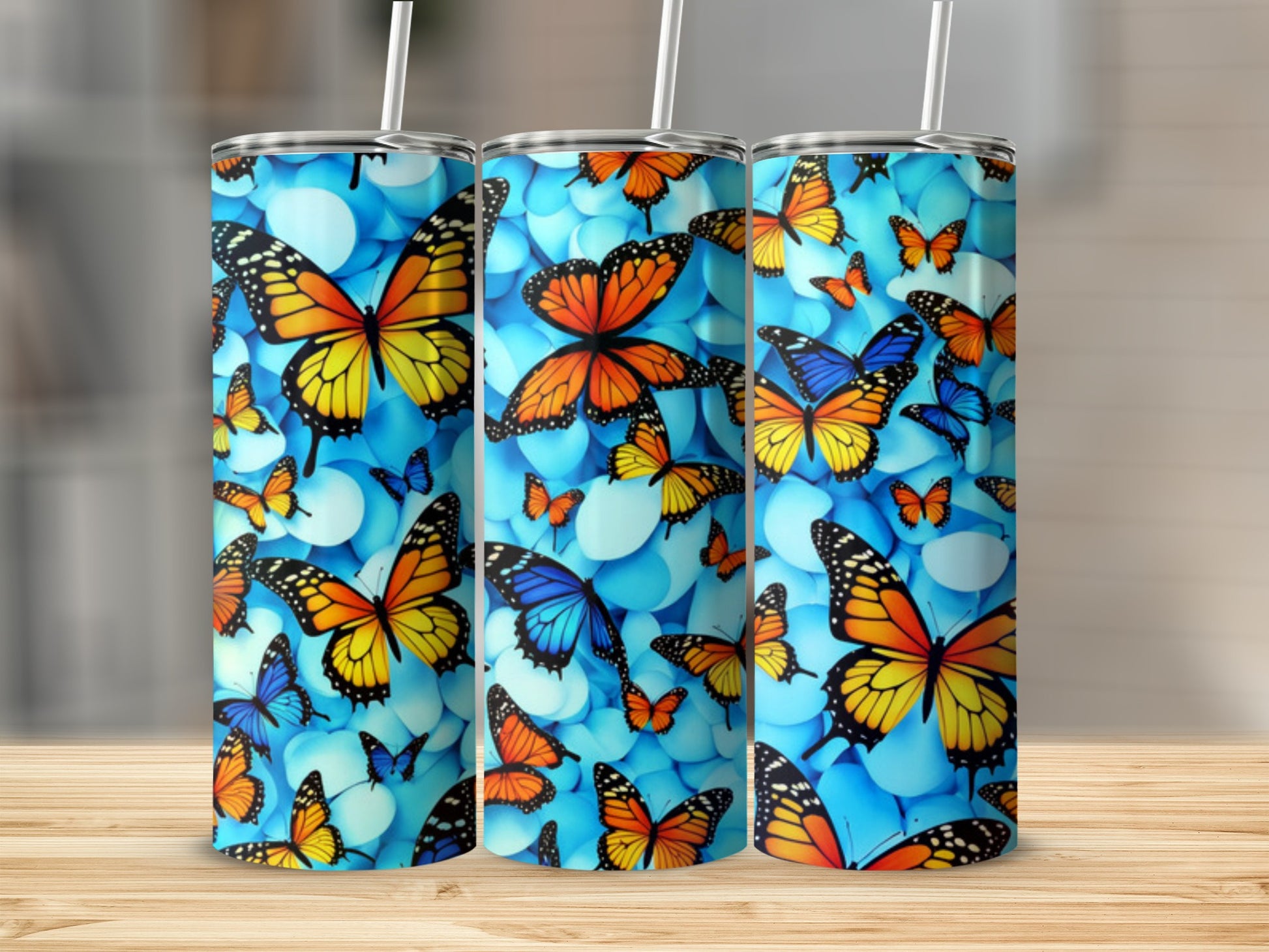 Blue tumbler with colorful butterflies and white marble pattern.