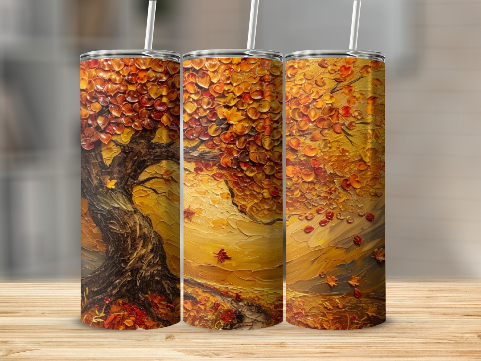 Fall tree design on three tumblers with straws.