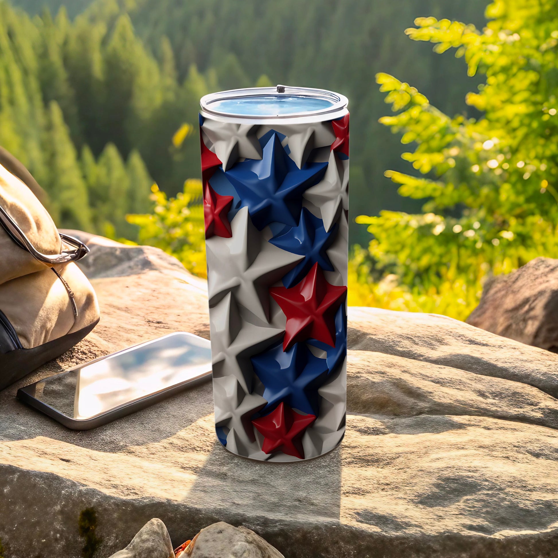 Tumbler with red, white, and blue stars pattern, sits on rock.