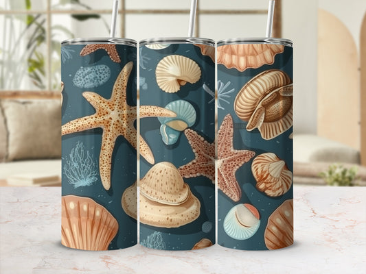 Tumbler with seashells, starfish, and coral pattern on a dark blue background.