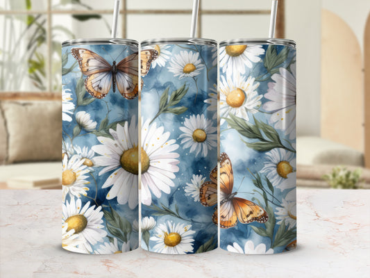 Three tumblers with daisies and butterflies against a watercolor floral background.