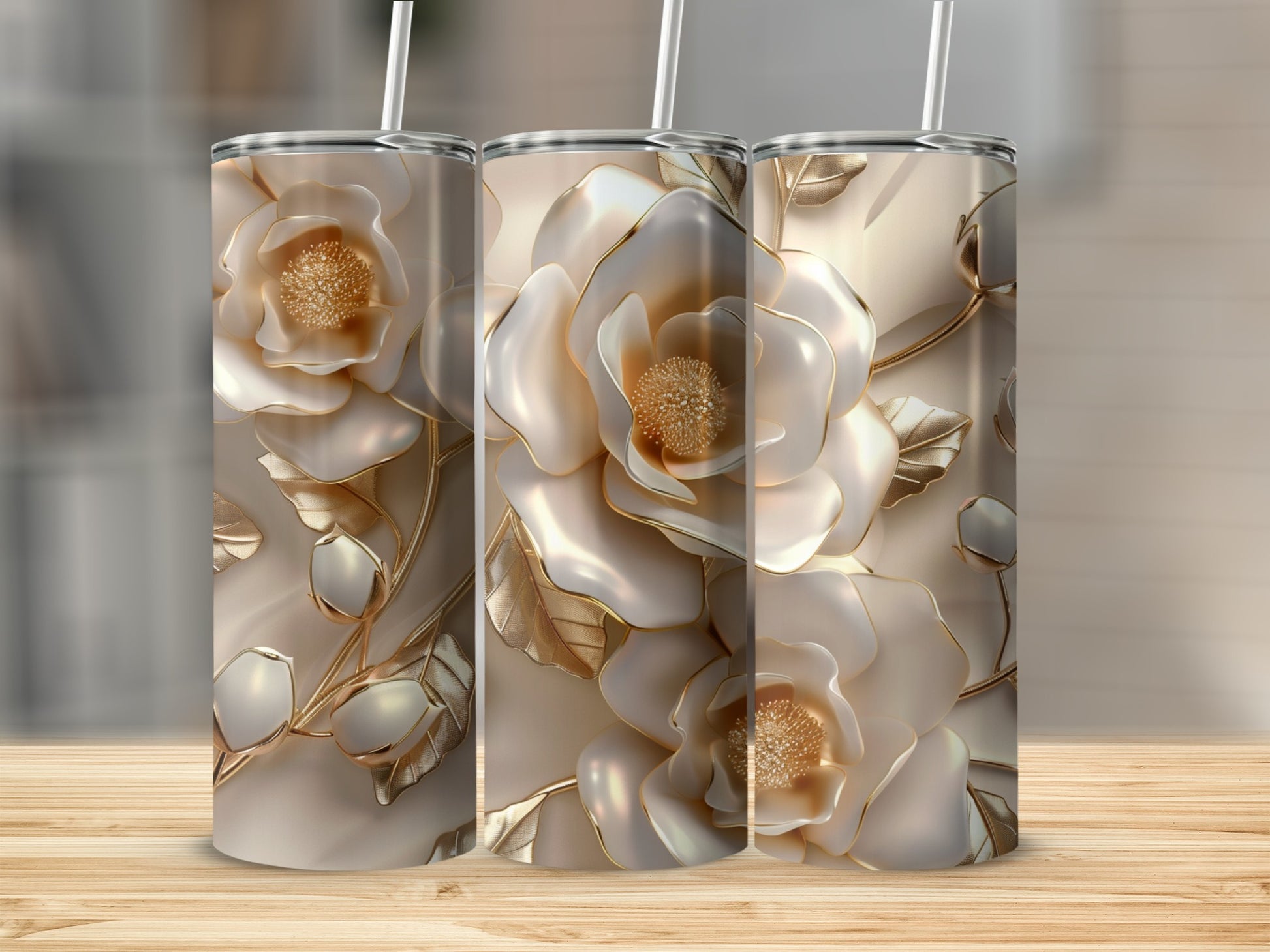 Three tall tumblers with intricate floral designs and gold accents.