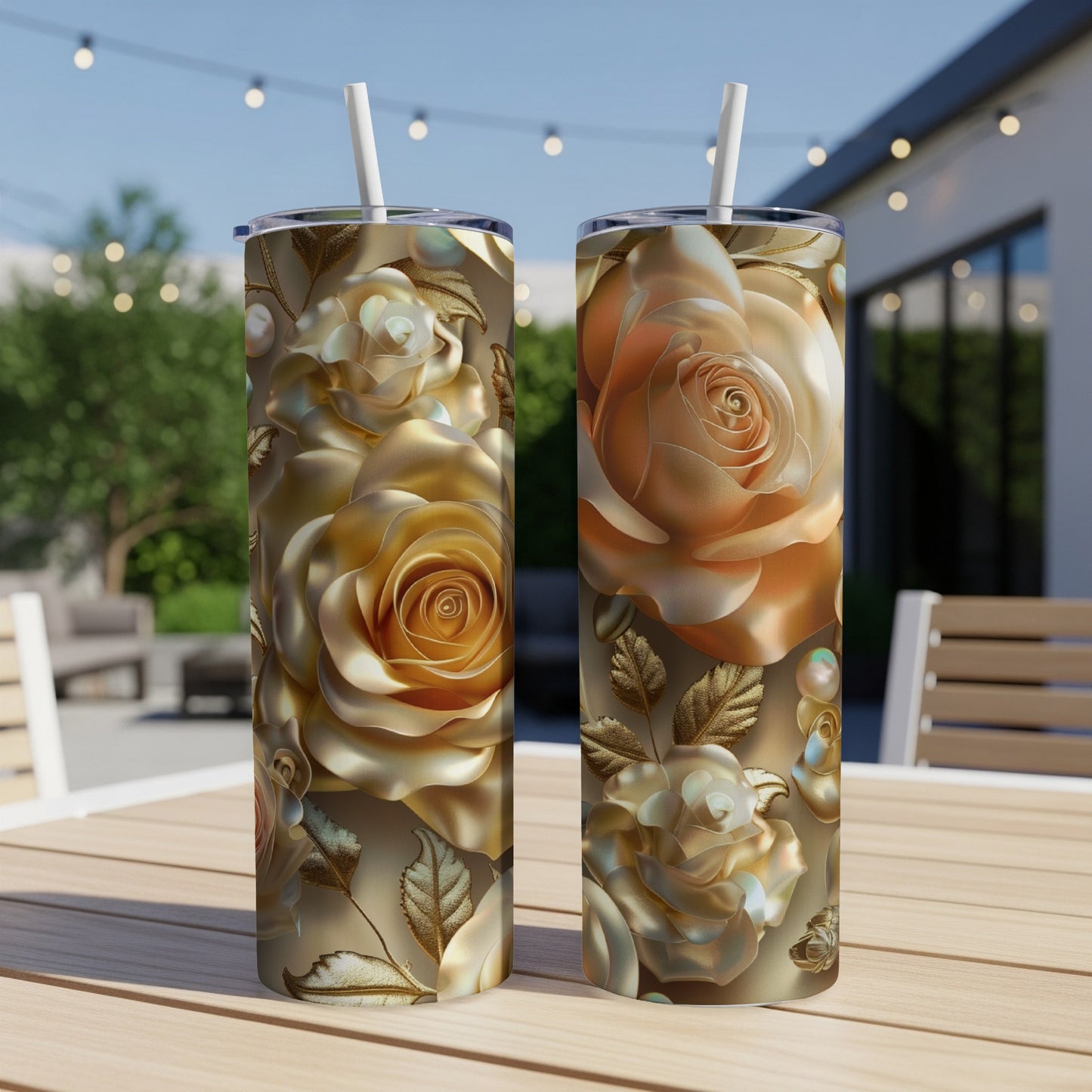 Two golden rose-patterned tumblers on a table outdoors.