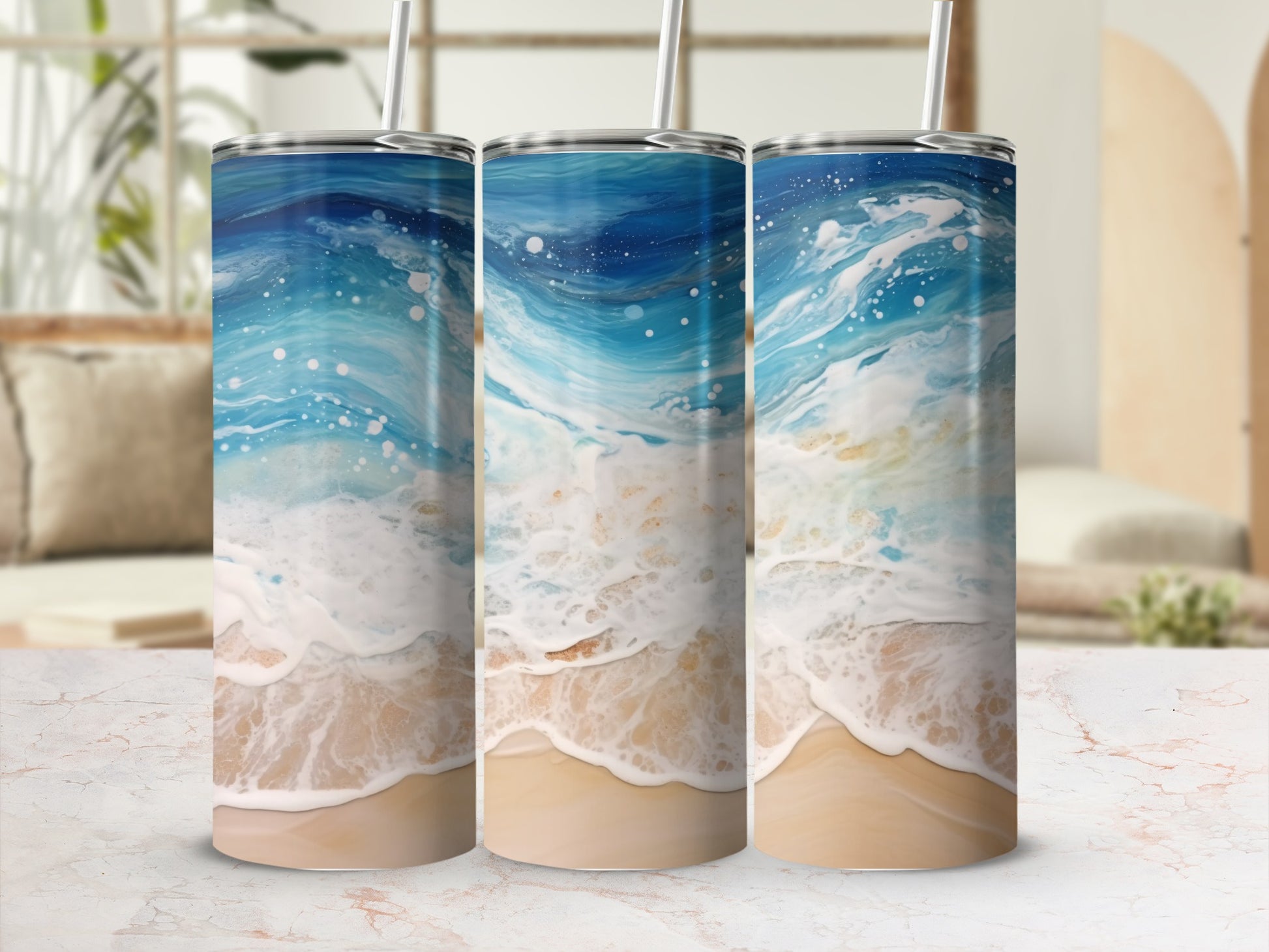 Three tumblers with a swirling blue ocean wave and sand design.