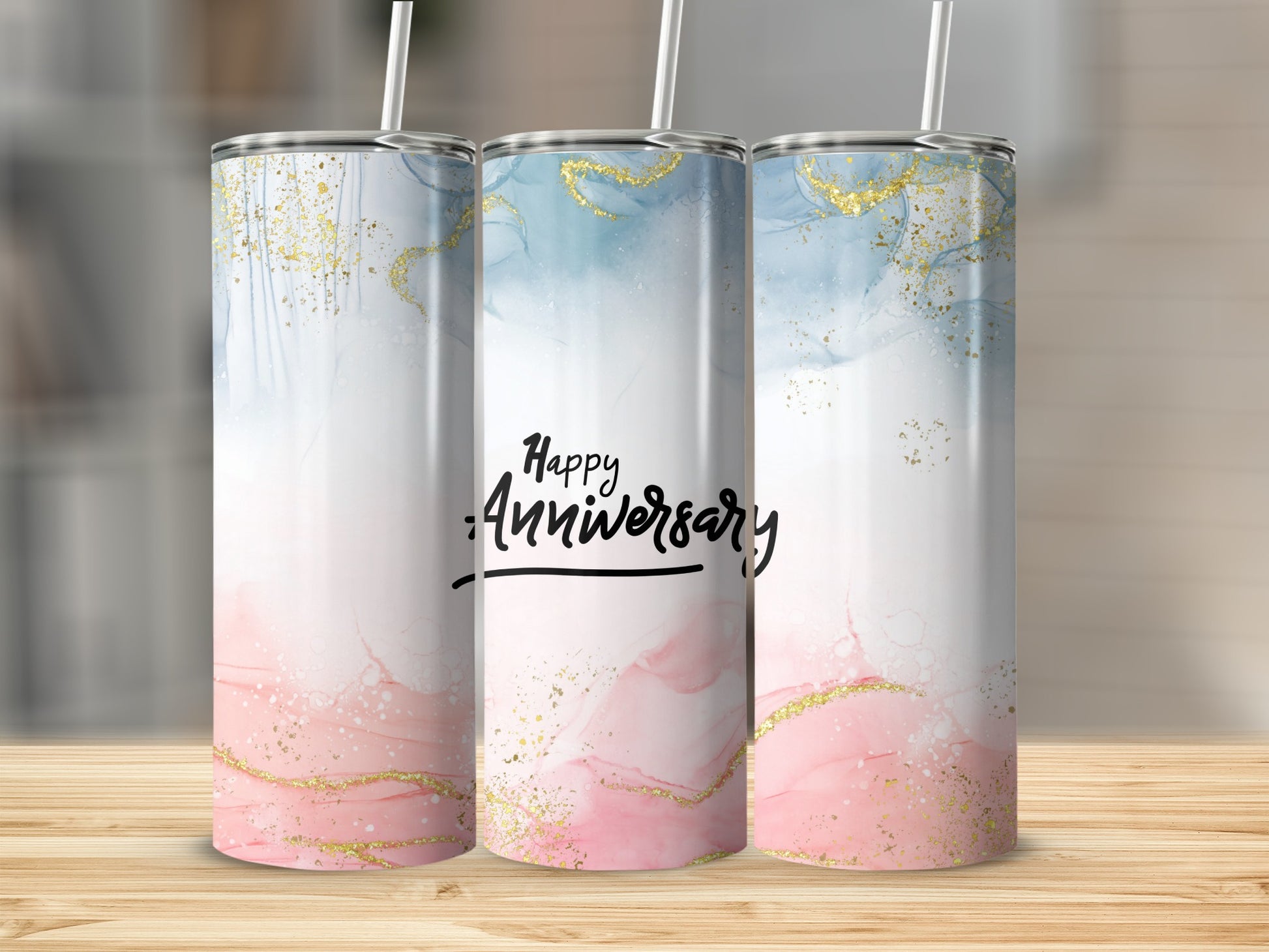 Three tumblers with pink and blue marble design and gold glitter accents, reading "Happy Anniversary".