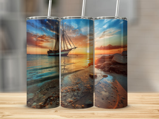 Sailboat at sunset on a rocky beach with colorful sky.