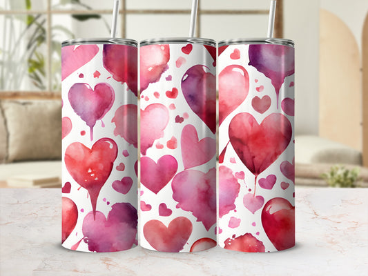 Pink and red watercolor hearts pattern on a skinny tumbler.