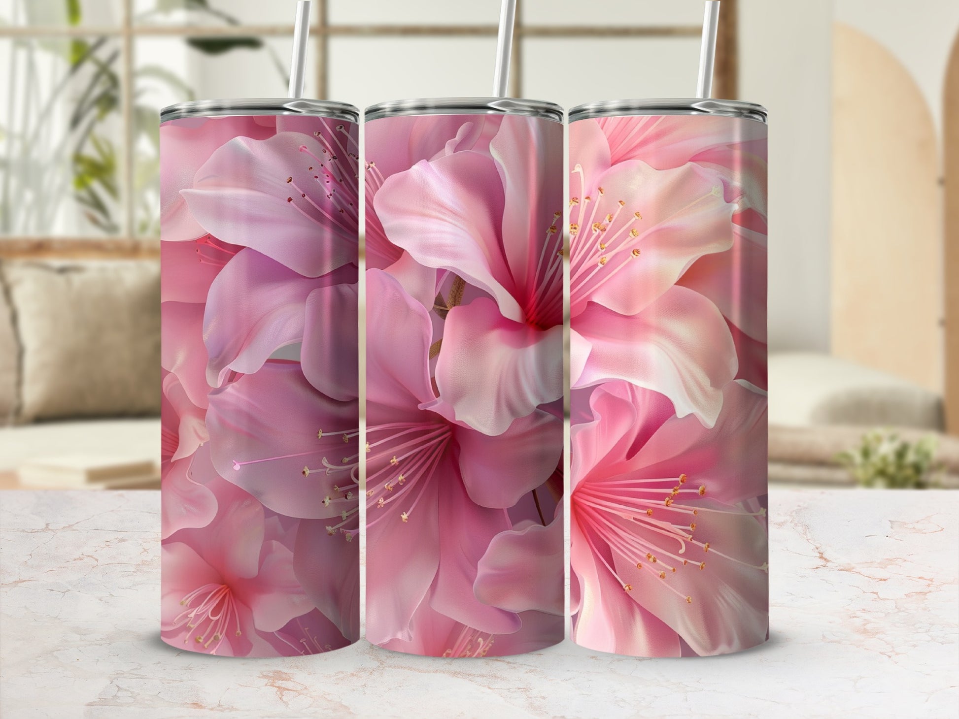 Three tumblers with pink floral pattern and straws.