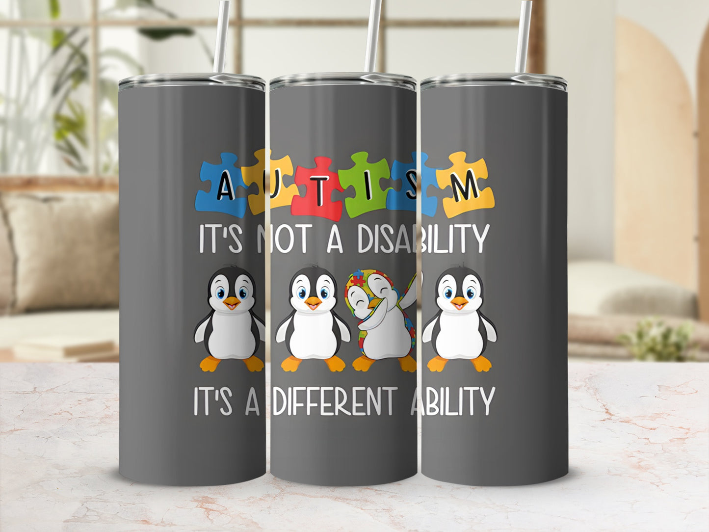 Tumbler with penguins, puzzle pieces, and "Autism It's Not A Disability It's A Different Ability" text.