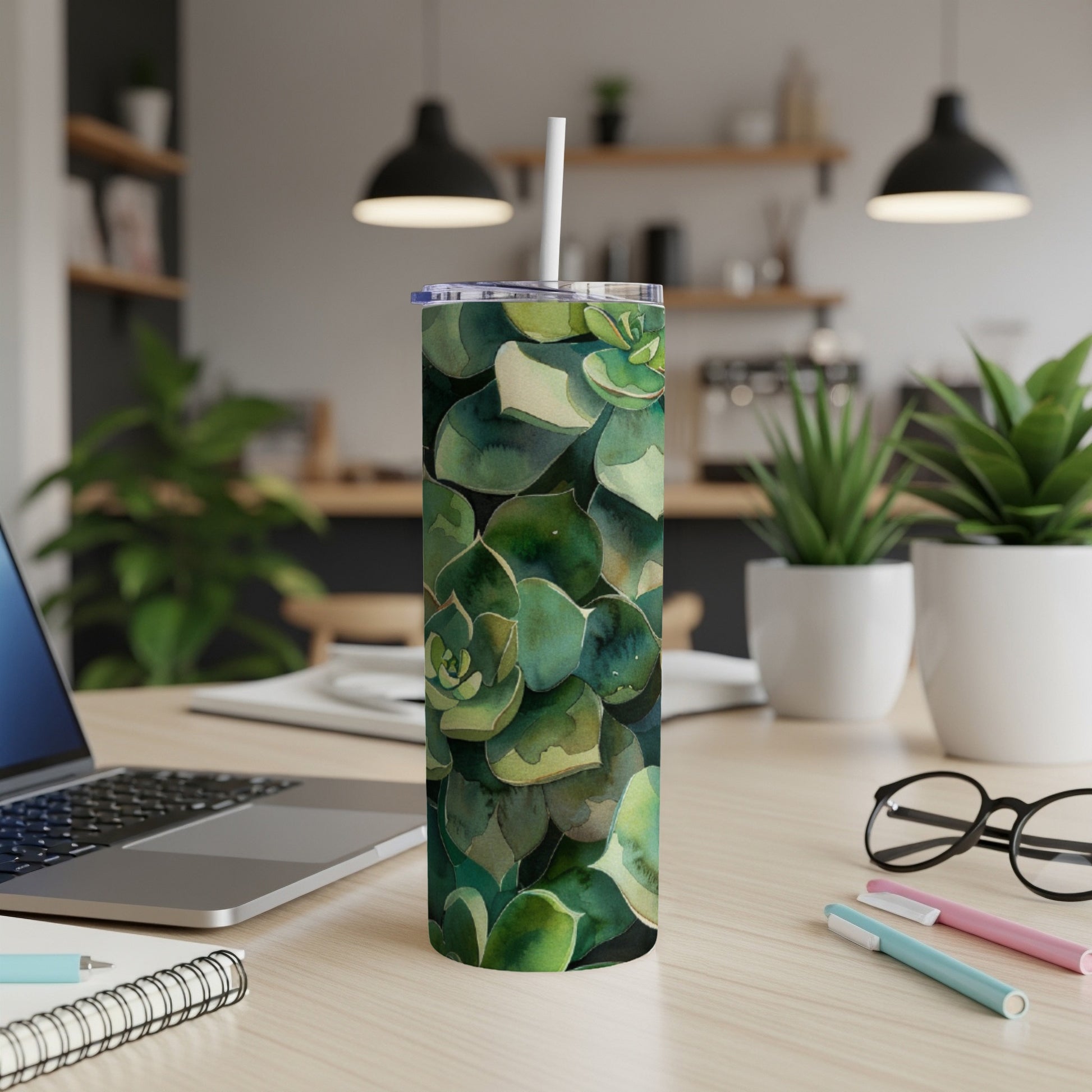 Green succulent plant pattern on a white tumbler with a straw.