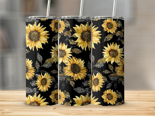 Three tumblers with a black background and yellow sunflower and leopard print designs.