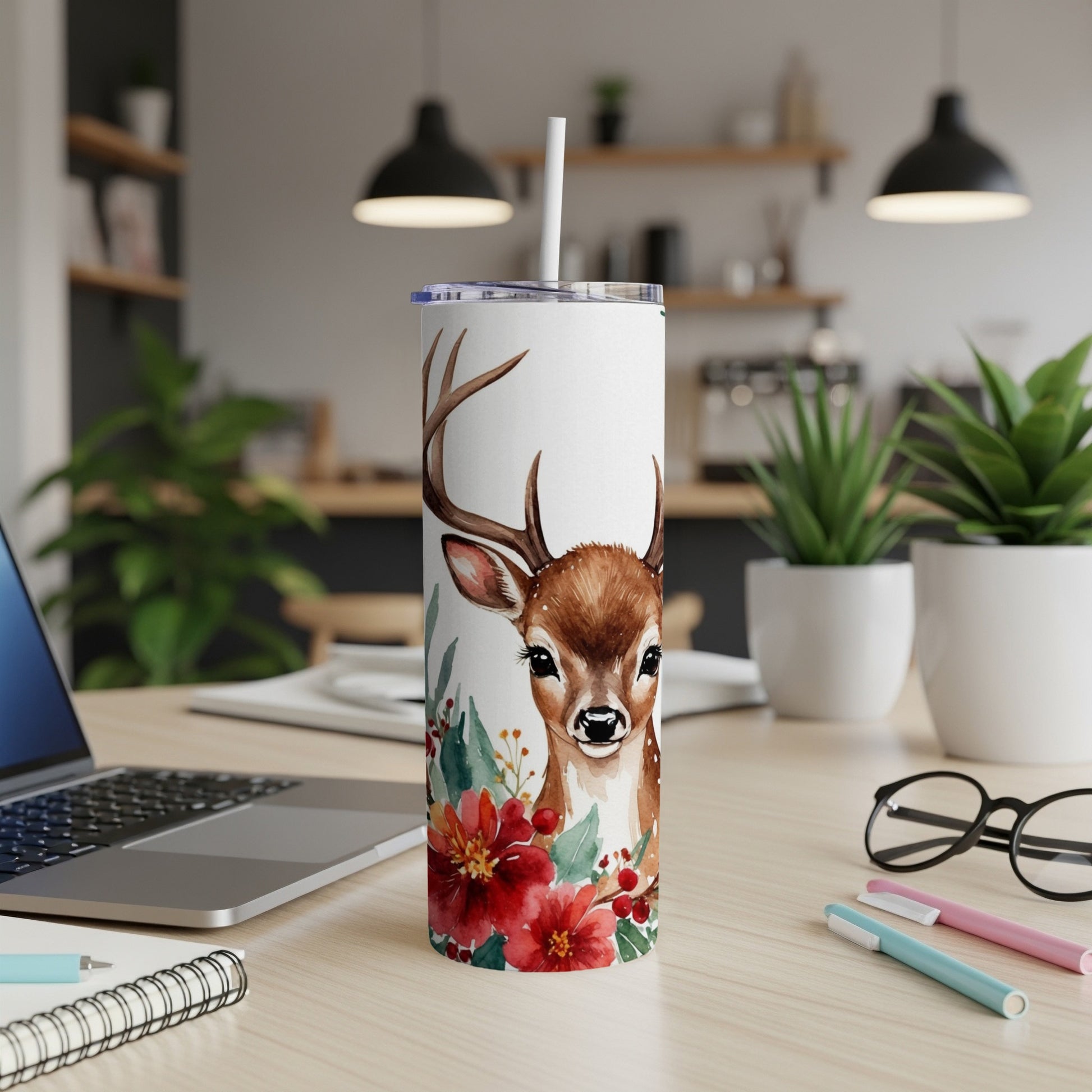 White tumbler with deer and floral design, featuring a straw and lid.