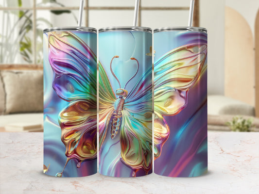 Iridescent butterfly tumbler with straw on marble countertop.