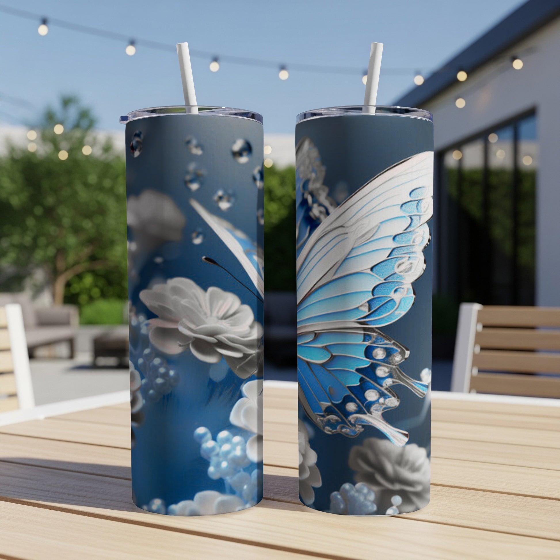 Two tall blue tumblers with white butterfly and floral design.