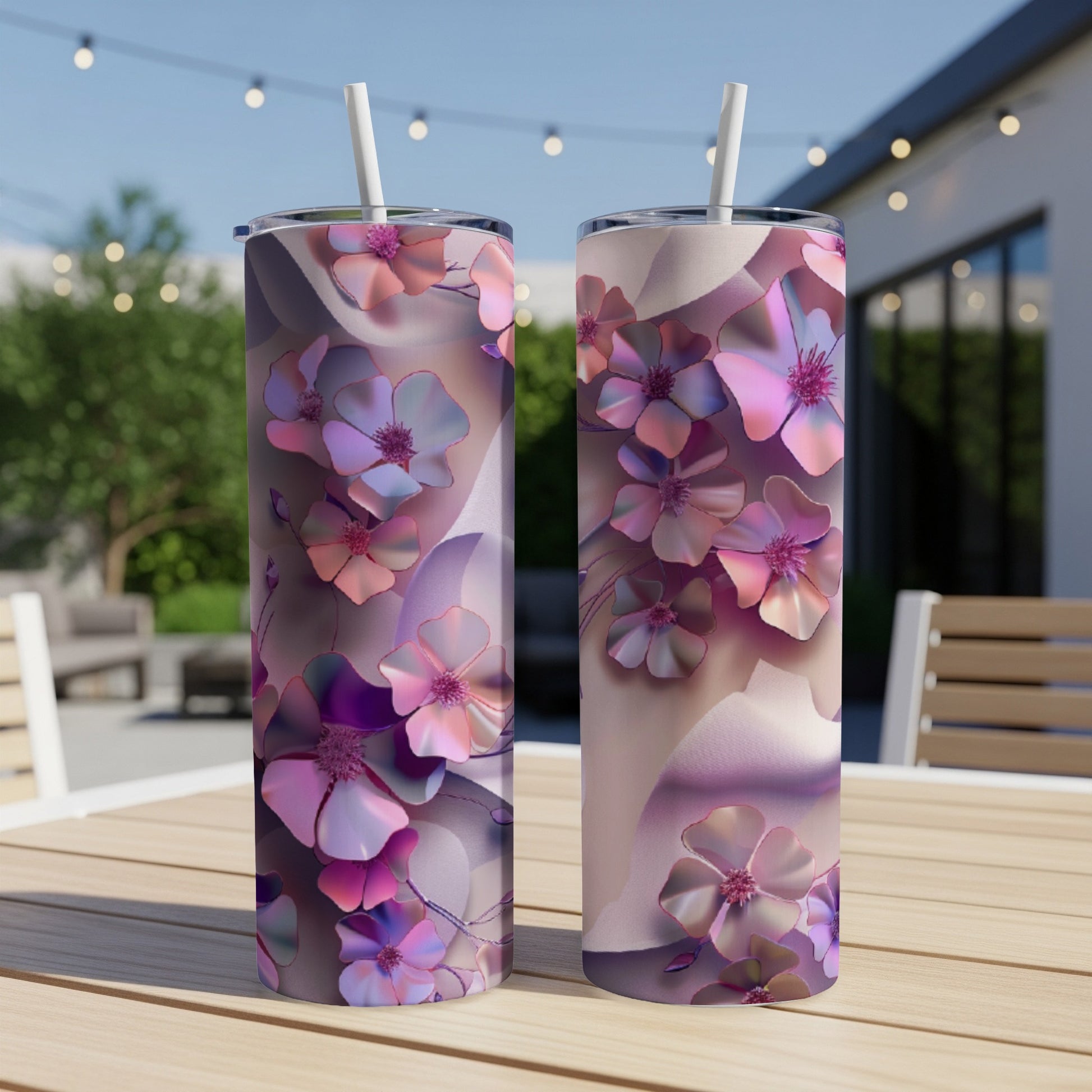 Two floral print tumblers with pink and purple flowers on a wooden table.